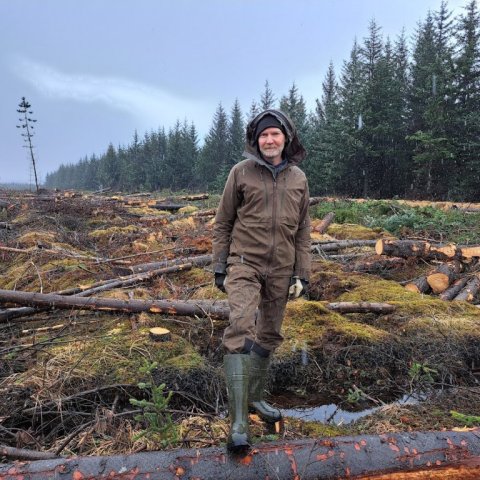 Jóhannes Sigurðsson aðstoðarskógarvörður með fellda reitinn í baksýn. Ljósmynd: Trausti Jóhannsson