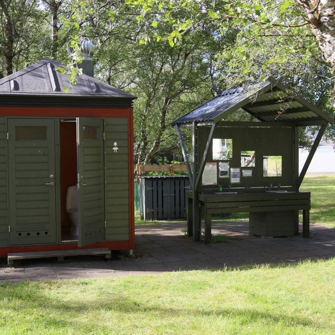 Snyrtingar og vaskar með upplýsingatöflu í Atlavík. Ljósmynd: Pétur Halldórsson