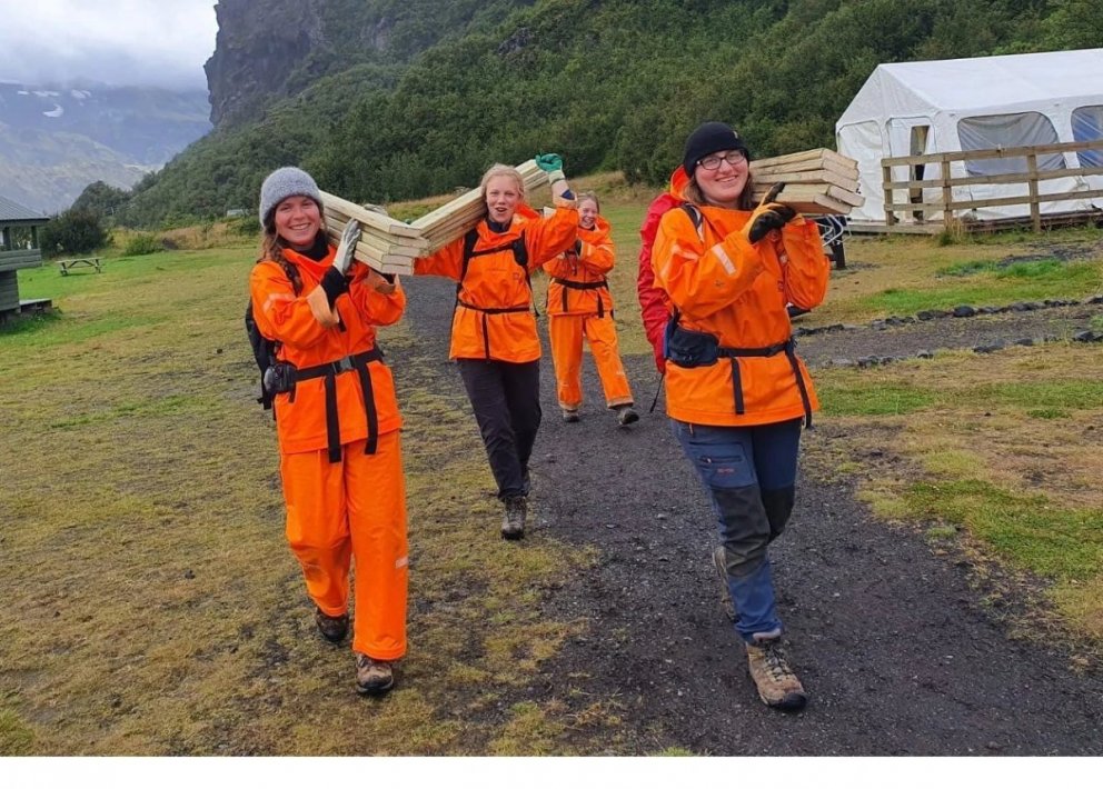 Cheerful volunteers set of from the Icelandic Forest Service facilities in Langidalur carrying build…
